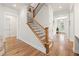 Open foyer features hardwood floors, a staircase with iron spindles, and natural light from front door at 1589 Bennett Creek Overlook, Suwanee, GA 30024