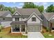 Charming two-story brick home with a covered porch and manicured landscaping at 1589 Bennett Creek Overlook, Suwanee, GA 30024