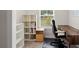Bright home office features built-in shelving and a dark wood desk, perfect for a productive work environment at 1589 Bennett Creek Overlook, Suwanee, GA 30024