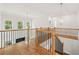 Upstairs landing with hardwood floors, black iron railings, and staircase views to lower floor at 1589 Bennett Creek Overlook, Suwanee, GA 30024