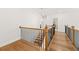 Second floor landing featuring hardwood floors, white walls, and views of lower level staircase at 1589 Bennett Creek Overlook, Suwanee, GA 30024