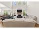 A sun drenched open-concept living space features a fireplace and direct access to the kitchen and dining room at 1589 Bennett Creek Overlook, Suwanee, GA 30024