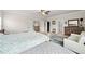 Large primary bedroom boasts neutral carpet, sitting area, and multiple bright windows at 1589 Bennett Creek Overlook, Suwanee, GA 30024