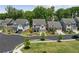 A residential streetscape with neatly arranged homes, well-maintained lawns and young trees lining the sidewalks at 1589 Bennett Creek Overlook, Suwanee, GA 30024