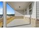 Covered back porch with views of the surrounding neighborhood and well-manicured yard at 1682 Juniper Berry Way, Loganville, GA 30052