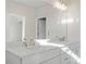 A bright bathroom featuring granite counters, a double sink vanity, decorative lighting and a mirror at 1682 Juniper Berry Way, Loganville, GA 30052