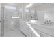 A modern bathroom with a glass-enclosed shower, white marbled tile and a double sink vanity at 1682 Juniper Berry Way, Loganville, GA 30052