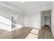 Large bedroom with trey ceiling, luxury vinyl plank floors and entry into a bathroom at 1682 Juniper Berry Way, Loganville, GA 30052