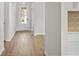 Spacious hallway with hardwood floors leading to various rooms in the home at 1682 Juniper Berry Way, Loganville, GA 30052