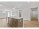 Stylish kitchen island features stainless steel hardware, bar seating, and quartz counters at 1682 Juniper Berry Way, Loganville, GA 30052