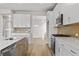 Open kitchen with island, stainless steel appliances, and ample storage space at 1682 Juniper Berry Way, Loganville, GA 30052
