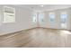 Bright living area boasts luxury vinyl flooring and large windows at 1682 Juniper Berry Way, Loganville, GA 30052