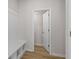 Mud room featuring built-in storage, a bench, and an adjacent doorway at 1682 Juniper Berry Way, Loganville, GA 30052