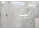 Modern shower features white marble tile, glass door, and bench at 1682 Juniper Berry Way, Loganville, GA 30052