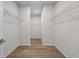 Spacious walk-in closet with luxury vinyl plank flooring and wire shelving at 1682 Juniper Berry Way, Loganville, GA 30052