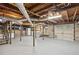 Unfinished basement with stairs, utility connections, and access to garage at 2672 Birchwood Dr, Atlanta, GA 30305