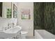 Bathroom featuring a vintage style pedestal sink and black and white patterned tile floor at 2672 Birchwood Dr, Atlanta, GA 30305