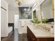 Bathroom featuring a double vanity with marble countertop and gold-framed mirrors at 2672 Birchwood Dr, Atlanta, GA 30305