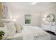 Bright bedroom showcasing a white dresser, round mirror, and light-colored bedding at 2672 Birchwood Dr, Atlanta, GA 30305