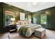 Bedroom featuring rich green walls, natural light, and comfortable bedding at 2672 Birchwood Dr, Atlanta, GA 30305