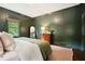 Bedroom featuring rich green walls, natural light, and comfortable bedding at 2672 Birchwood Dr, Atlanta, GA 30305
