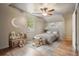Cozy bedroom with neutral colors, ceiling fan, rug, and moon decor at 2672 Birchwood Dr, Atlanta, GA 30305