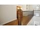 Hallway with elegant wood floors, wood railing, and dark iron spindles at 2672 Birchwood Dr, Atlanta, GA 30305