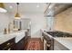 A kitchen featuring marble counters, a farmhouse sink, and an elegant stainless steel range at 2672 Birchwood Dr, Atlanta, GA 30305