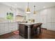 A modern kitchen featuring a central island, marble countertops, and stylish pendant lighting at 2672 Birchwood Dr, Atlanta, GA 30305