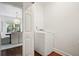 Bright laundry room with white washer and dryer, plus adjacent dining room at 2672 Birchwood Dr, Atlanta, GA 30305