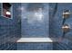 Blue tiled shower with a built-in seat and sleek fixtures at 2672 Birchwood Dr, Atlanta, GA 30305