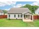 View of the back of the home, featuring a covered patio, and a fenced yard at 306 Lark Ln, Canton, GA 30115