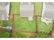 Aerial view of a fenced backyard with lush green grass, landscaping, and a small storage shed at 306 Lark Ln, Canton, GA 30115
