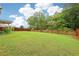 Backyard with lush green grass and wooden fence at 306 Lark Ln, Canton, GA 30115