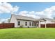 Large backyard featuring green grass, wood fence, and home exterior at 306 Lark Ln, Canton, GA 30115
