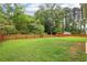 Spacious backyard featuring a wooden fence and lush green grass at 306 Lark Ln, Canton, GA 30115