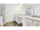 A spacious bathroom featuring double sinks, granite counters, white cabinets, and a separate shower at 306 Lark Ln, Canton, GA 30115