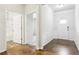 Inviting foyer featuring hardwood floors and decorative wainscoting, leading to a bathroom and carpeted hall at 306 Lark Ln, Canton, GA 30115