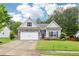 Charming single-Gathering home with stone accents, a well-manicured lawn, and a two-car garage at 306 Lark Ln, Canton, GA 30115