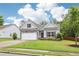 Attractive home with a well-maintained lawn, stone details, and an attached two-car garage at 306 Lark Ln, Canton, GA 30115
