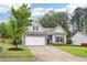 Inviting home featuring a stone-accented facade, attached garage, and a beautifully landscaped front yard at 306 Lark Ln, Canton, GA 30115