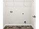 A utility room with a wire shelf, tile flooring, and access to plumbing and electrical connections at 306 Lark Ln, Canton, GA 30115