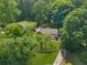 Aerial view of the home showcasing the lush landscaping, surrounding trees, and well-maintained lawn at 3116 Lakepoint Cir, Acworth, GA 30102