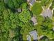 An aerial view showcasing a home surrounded by lush greenery and a serene pool at 3116 Lakepoint Cir, Acworth, GA 30102