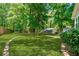 Expansive backyard featuring lush lawn, mature trees, gazebo, and pathway, perfect for outdoor enjoyment at 3116 Lakepoint Cir, Acworth, GA 30102