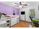 Stylish bedroom with desk, lofted bed, guitar, and large window providing plenty of natural light at 3116 Lakepoint Cir, Acworth, GA 30102