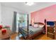 Cozy bedroom with a classic bed frame, hardwood floors, and a charming window letting in natural light at 3116 Lakepoint Cir, Acworth, GA 30102