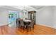 Dining room with hardwood floors, dining table with upholstered chairs, and dark wood cabinet at 3116 Lakepoint Cir, Acworth, GA 30102