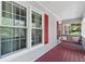 Inviting front porch with swing, white framed windows, and painted wood flooring at 3116 Lakepoint Cir, Acworth, GA 30102