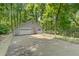Detached two-car garage with gray exterior, driveway, and fenced yard at 3116 Lakepoint Cir, Acworth, GA 30102